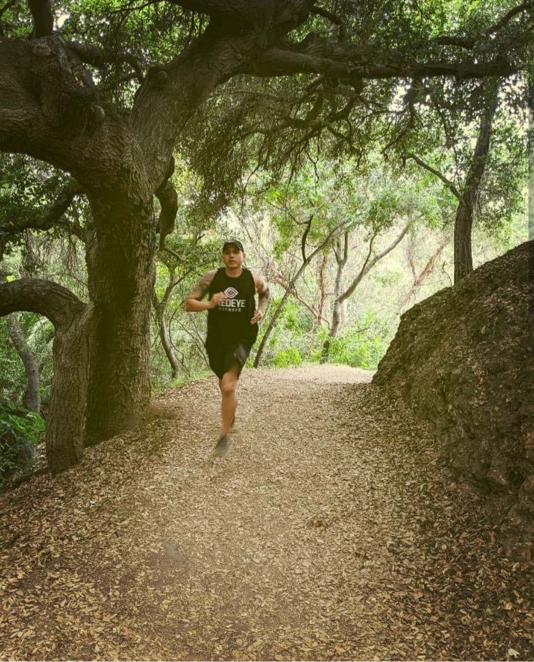 The founder mid-run on a Los Angeles trail in the REDEYE FITNESS tank, July 2019